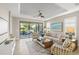 Comfortable living room with a large window, modern furniture, tile floors and access to the screened-in lanai at 5556 Cantucci St, Nokomis, FL 34275