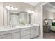 Bright main bathroom features double sinks, quartz countertops, walk-in shower, and ensuite access at 5556 Cantucci St, Nokomis, FL 34275