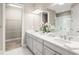 Bright main bathroom features double sinks, quartz countertops, and walk in closet at 5556 Cantucci St, Nokomis, FL 34275