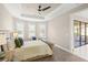 Bright main bedroom features trey ceiling, ceiling fan, neutral colors, and plantation shutters at 5556 Cantucci St, Nokomis, FL 34275