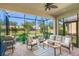 Covered patio overlooking a well-maintained yard with outdoor seating at 5556 Cantucci St, Nokomis, FL 34275