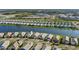 Picturesque aerial shot of homes nestled by a tranquil lake featuring manicured lawns and serene scenery at 8071 Slipway Dr, Sarasota, FL 34240