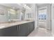 Modern bathroom featuring double sinks, granite countertops, and a walk-in shower at 8071 Slipway Dr, Sarasota, FL 34240