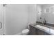 Bathroom featuring vanity with gray countertop, glass shower, and white tiled walls at 8071 Slipway Dr, Sarasota, FL 34240