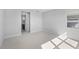 Large bedroom with neutral walls, plush carpet, and access to an ensuite bathroom at 8071 Slipway Dr, Sarasota, FL 34240