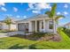 A beautiful single story home featuring an attached garage and a meticulously landscaped front yard at 8071 Slipway Dr, Sarasota, FL 34240