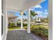 Inviting front porch with manicured landscaping in a tranquil setting at 8071 Slipway Dr, Sarasota, FL 34240