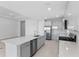 Modern kitchen with stainless steel appliances, quartz countertops and an island sink at 8071 Slipway Dr, Sarasota, FL 34240