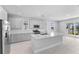 Modern kitchen with stainless steel appliances, quartz countertops, and views of the lake at 8071 Slipway Dr, Sarasota, FL 34240