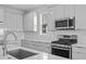 Modern kitchen with stainless steel appliances, quartz countertops and plentiful counter space at 8071 Slipway Dr, Sarasota, FL 34240