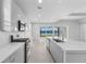 Modern kitchen with stainless steel appliances, quartz countertops, and views of the lake at 8071 Slipway Dr, Sarasota, FL 34240