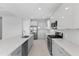 Modern kitchen with stainless steel appliances, quartz countertops and an island sink at 8071 Slipway Dr, Sarasota, FL 34240