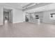 An open-concept living area featuring tile floors, recessed lighting, and a kitchen with modern appliances at 8071 Slipway Dr, Sarasota, FL 34240
