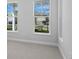 Bright living room featuring gray walls and large windows that offer neighborhood views at 8071 Slipway Dr, Sarasota, FL 34240