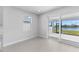 An airy room with tile flooring, recessed lighting, a large sliding glass door and a window offering lake view at 8071 Slipway Dr, Sarasota, FL 34240