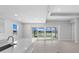 Bright and airy living space featuring large sliding glass doors offering beautiful views of the backyard and lake at 8071 Slipway Dr, Sarasota, FL 34240