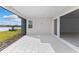 Spacious covered patio with serene lake views and ample natural light at 8071 Slipway Dr, Sarasota, FL 34240