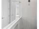 Bright white shower with rainfall shower head and tile surround at 8071 Slipway Dr, Sarasota, FL 34240