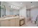 Well-lit bathroom with vanity area, a stylish sink, and shower-tub combo behind sliding glass doors at 888 Blvd Of The Arts # 1008, Sarasota, FL 34236