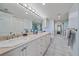 Elegant bathroom featuring dual sinks, plenty of cabinet space, and a large mirror at 888 Blvd Of The Arts # 1008, Sarasota, FL 34236