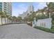 Elegant condo entrance with beautiful landscaping and a decorative gate for added privacy and curb appeal at 888 Blvd Of The Arts # 1008, Sarasota, FL 34236
