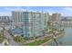 Elegant waterfront condominium building featuring private balconies with serene views of the water at 888 Blvd Of The Arts # 1008, Sarasota, FL 34236