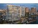 Exterior view of modern high-rise condominiums on the water with a view of the city at 888 Blvd Of The Arts # 1008, Sarasota, FL 34236