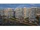 Modern high-rise condominium building with private docks and lush tropical landscaping and city skyline in the background at 888 Blvd Of The Arts # 1008, Sarasota, FL 34236