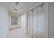 Bright hallway with mirrored closet doors and recessed lighting at 888 Blvd Of The Arts # 1008, Sarasota, FL 34236