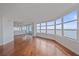 Open-concept living room with hardwood floors and a view of the balcony and water at 888 Blvd Of The Arts # 1008, Sarasota, FL 34236