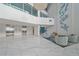 Grand condo lobby with modern decor, tile flooring, comfortable seating, and elevator access at 888 Blvd Of The Arts # 1008, Sarasota, FL 34236