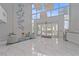Bright condo lobby featuring high ceilings, elegant seating, and large windows with outdoor views at 888 Blvd Of The Arts # 1008, Sarasota, FL 34236