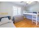 Bedroom featuring natural light, hardwood floors, ceiling fan and bunk beds at 916 Michigan Ave, Palm Harbor, FL 34683