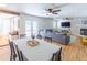 View of the dining room adjacent to a living area with a cozy fireplace and abundant natural light at 916 Michigan Ave, Palm Harbor, FL 34683