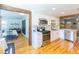 Updated kitchen featuring stainless steel appliances, white cabinets, and hardwood floors at 916 Michigan Ave, Palm Harbor, FL 34683