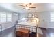 Serene main bedroom with ceiling fan, and dark-toned wood floors at 916 Michigan Ave, Palm Harbor, FL 34683