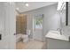 Bright bathroom with a combined tub and shower, neutral wall tile and modern vanity at 115 24Th W St, Bradenton, FL 34205