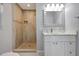 Bathroom featuring a beautifully tiled shower and vanity with a marble countertop at 115 24Th W St, Bradenton, FL 34205