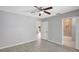 Spacious bedroom with modern gray walls, ceiling fan, and views to other rooms at 115 24Th W St, Bradenton, FL 34205