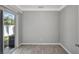 Bedroom with vinyl floor and sliding glass door with view to back yard at 115 24Th W St, Bradenton, FL 34205
