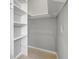 A spacious walk-in closet provides ample storage with shelving at 115 24Th W St, Bradenton, FL 34205