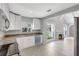 Bright kitchen with white cabinetry, granite countertops, stainless steel appliances and a view into the living room at 115 24Th W St, Bradenton, FL 34205