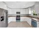 Modern kitchen with white cabinets, stainless steel appliances and granite countertops provides an elegant space for cooking at 115 24Th W St, Bradenton, FL 34205