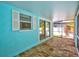 Enclosed patio featuring brick flooring, screen windows, and a sliding glass door provides private outdoor space at 115 24Th W St, Bradenton, FL 34205