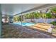 Enjoy the pool in the lush, private backyard from the covered patio at 115 24Th W St, Bradenton, FL 34205