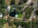 Aerial view of the property, highlighting its boundaries, pond, pool, house, and surrounding landscape at 1228 Wagon Wheel Dr, Sarasota, FL 34240