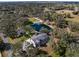 Expansive property featuring a house, private pond, pool, and lush greenery from an aerial perspective at 1228 Wagon Wheel Dr, Sarasota, FL 34240