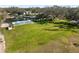 Vast lawn area with a view of the pond, pool, and the house, perfect for outdoor enjoyment at 1228 Wagon Wheel Dr, Sarasota, FL 34240