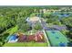 Aerial view of a playground and community amenities, including a pool, tennis, and basketball courts by the lake at 12520 23Rd E St, Parrish, FL 34219