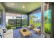 Enjoyable patio with lake views, outdoor seating, and beautiful tropical plants at 13232 Saw Palm Creek Trl, Bradenton, FL 34211